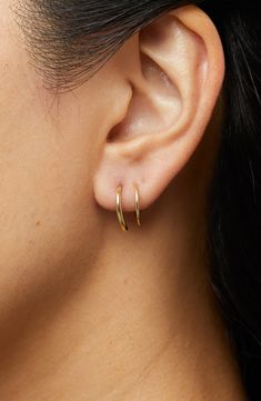 These hoops add the coolest detail to your look as they wrap around your ear, giving you the illusion of two piercings in one.How to wear: place thinner post through piercing. Turn earring approximately 2-3 times until both hoops are showing in the front to make a perfect double-pierced look. Avoid bending, style is delicate. Recycled Sterling Silver dipped in 14K Gold Delicate style, please handle with care Width: 5.5mm - 0.22" Depth: 13mm - 0.51" Weight: 0.60g Hoop Diameter: 13mm - 0.51” Post: Minimalist Gold Jewelry Earrings, Faux Double Hoop Earrings, Two Piercings, Double Piercing Earrings, Little Hoop Earrings, Double Earring, Gold Minimalist Jewelry, Double Earrings, Double Piercing