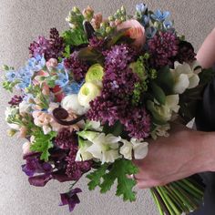 a person holding a bouquet of flowers in their hands