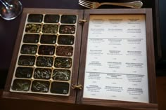 an open menu sitting on top of a wooden table