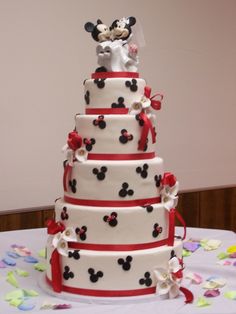 a wedding cake with mickey mouse on top