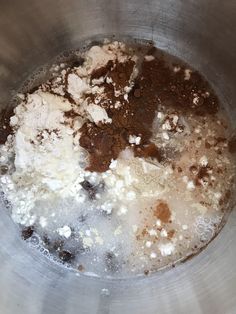 a metal bowl filled with brown and white ingredients