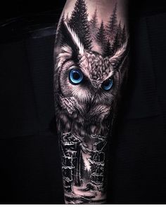 an owl with blue eyes is shown on the arm and leg, in black and white