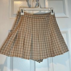 Plaid Skirt. Size : Small. Shorts On Inside. Yellow, Brown, White Plaid. Never Worn Before. Preppy Mini Skirt For Summer, Preppy Short Mini Skirt For Summer, Preppy Short Summer Mini Skirt, Preppy Short Length Mini Skirt For Summer, Cute Pleated Skort For Summer, Preppy Short Length Skort For Summer, Preppy Short-length Summer Skort, Preppy Pleated Short Skirt, Preppy Mini-length Bottoms For Day Out