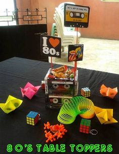 a table topped with lots of different types of toys and paper origami pieces