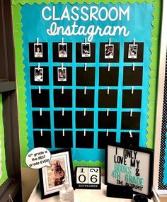 a classroom bulletin board with pictures and magnets on it, next to a small table