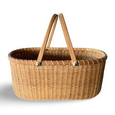 a wicker basket with two handles on the front and back sides, set against a white background