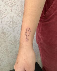 a person with a small tattoo on their wrist