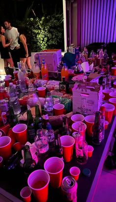 a table with many cups and bottles on it