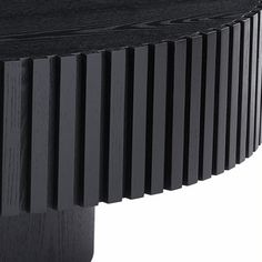 a close up of a black wooden table with vertical stripes on it's surface