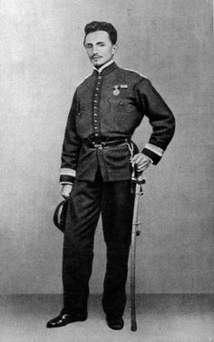 an old black and white photo of a man in uniform