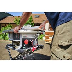 a man is using a table saw to cut wood with a circular sawtoother