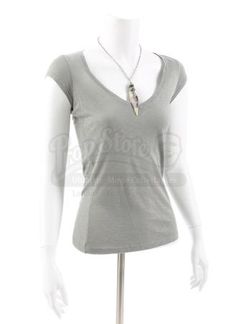 a white mannequin wearing a gray shirt and silver necklace on it's neck