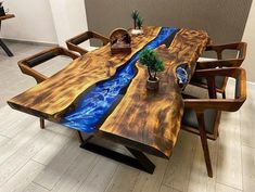 the table is made out of wood and has blue water running down it's sides