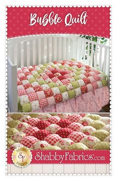 a crib bed with a red and green quilt