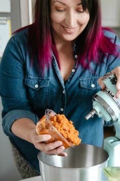 a woman is pouring something into a bowl