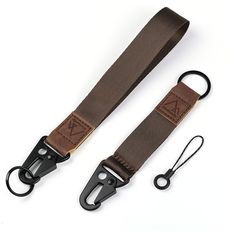 two brown straps with black handles on white background