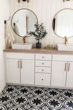 two sinks and mirrors in a bathroom with black and white floor tiles on the walls