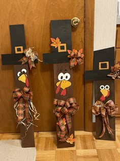 three scarecrows made to look like thanksgiving decorations