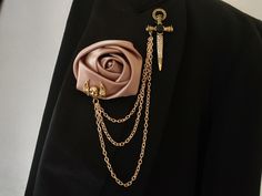 a close up of a person wearing a suit with a rose brooch on it