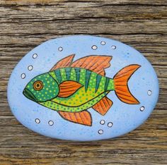 a painted rock with a fish on it