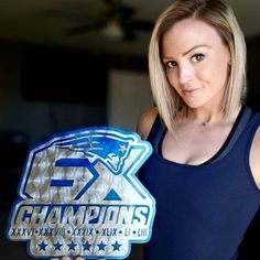 a woman holding up a plaque with the word champs on it in front of her