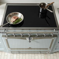 a pan with some food on top of it next to a stove and oven burner