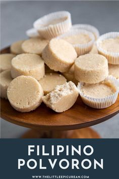 a wooden plate topped with cupcakes on top of a table next to the words, filipino polyvoron