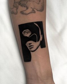 a person's arm with a tattoo on it that has a woman's face in black and white