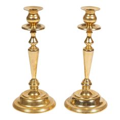 pair of brass candlesticks on white background