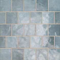 a white and blue tiled wall with no one in the photo or description on it