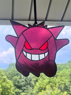 a pink cartoon character hanging from the ceiling