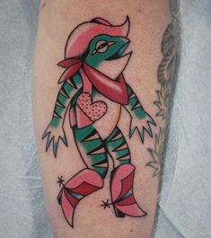 a colorful tattoo on the leg of a person with a bird and heart in it