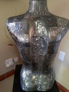 a large metal vase sitting on top of a table