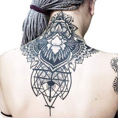 the back of a man's neck with tattoos on it and an image of a flower