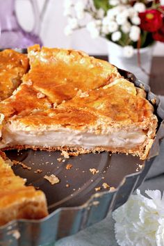 there is a pie that has been cut in half and ready to be served on the table