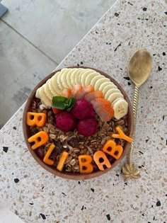 a bowl filled with fruit and cereal on top of a table