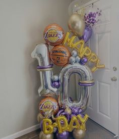 an air filled balloon that says happy 90th birthday with balloons in the shape of basketballs