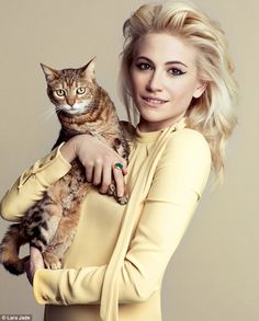 a woman holding a cat in her arms