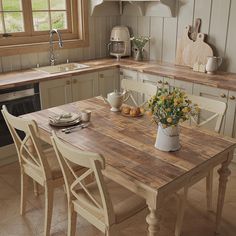 a wooden table sitting in the middle of a kitchen