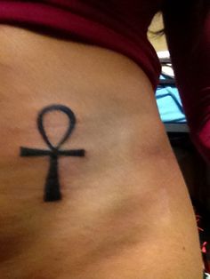 an egyptian symbol on the side of a woman's stomach