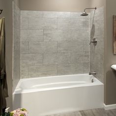 a white bath tub sitting inside of a bathroom