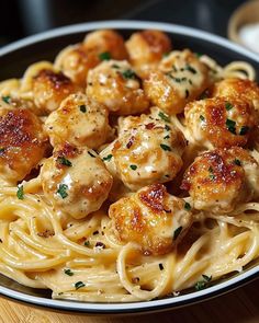 pasta with shrimp and parsley in a bowl on a wooden table, ready to be eaten