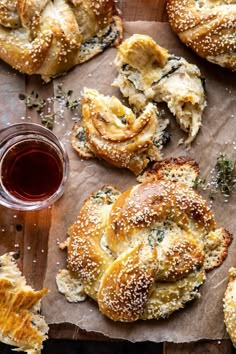 breads and other pastries on a table next to a cup of tea