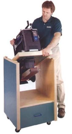 a man is working on an item in a small wooden cabinet with wheels and handles