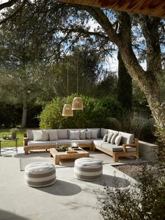 an outdoor living area with couches and tables