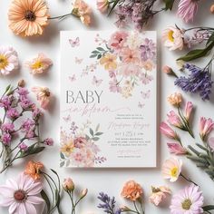 the baby announcement card is surrounded by pink and yellow flowers on a white background with butterflies