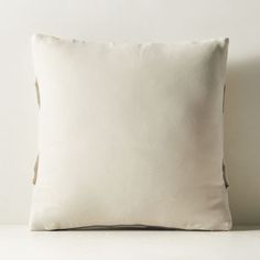 a white pillow sitting on top of a table