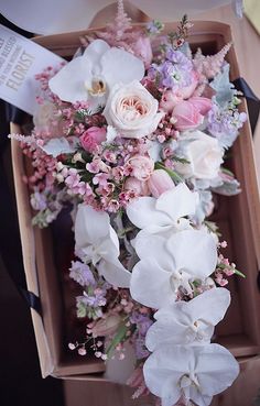 an arrangement of flowers in a wooden box