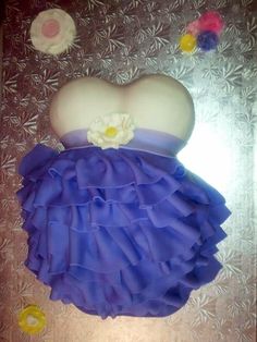 a cake shaped like a dress with flowers on it