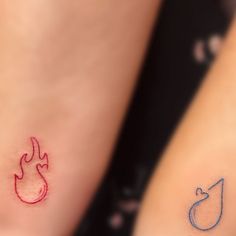 two small tattoos on their legs with fire and water symbols